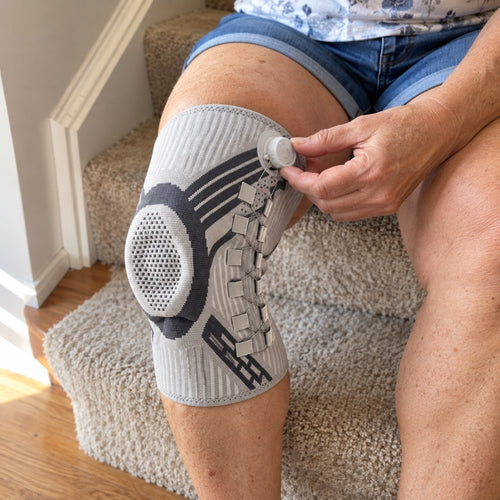 Woman on the stairs turning the dial on her Dialed knee brace